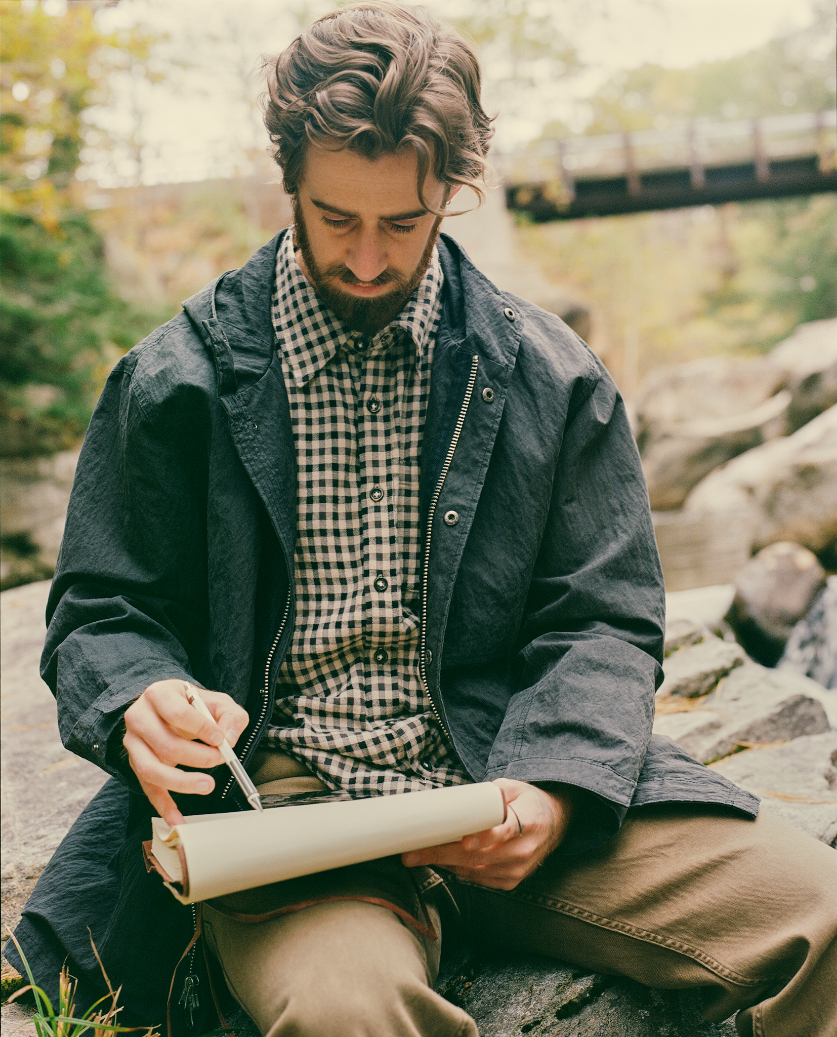 Stevie writing outside by a river